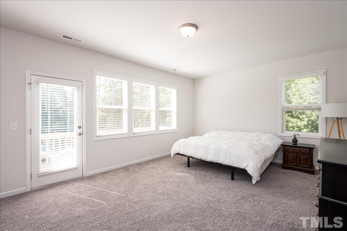3620 Buffaloe Road Raleigh, NC 27604 - Photo 10 of 18 a bed room with a bed and a chair