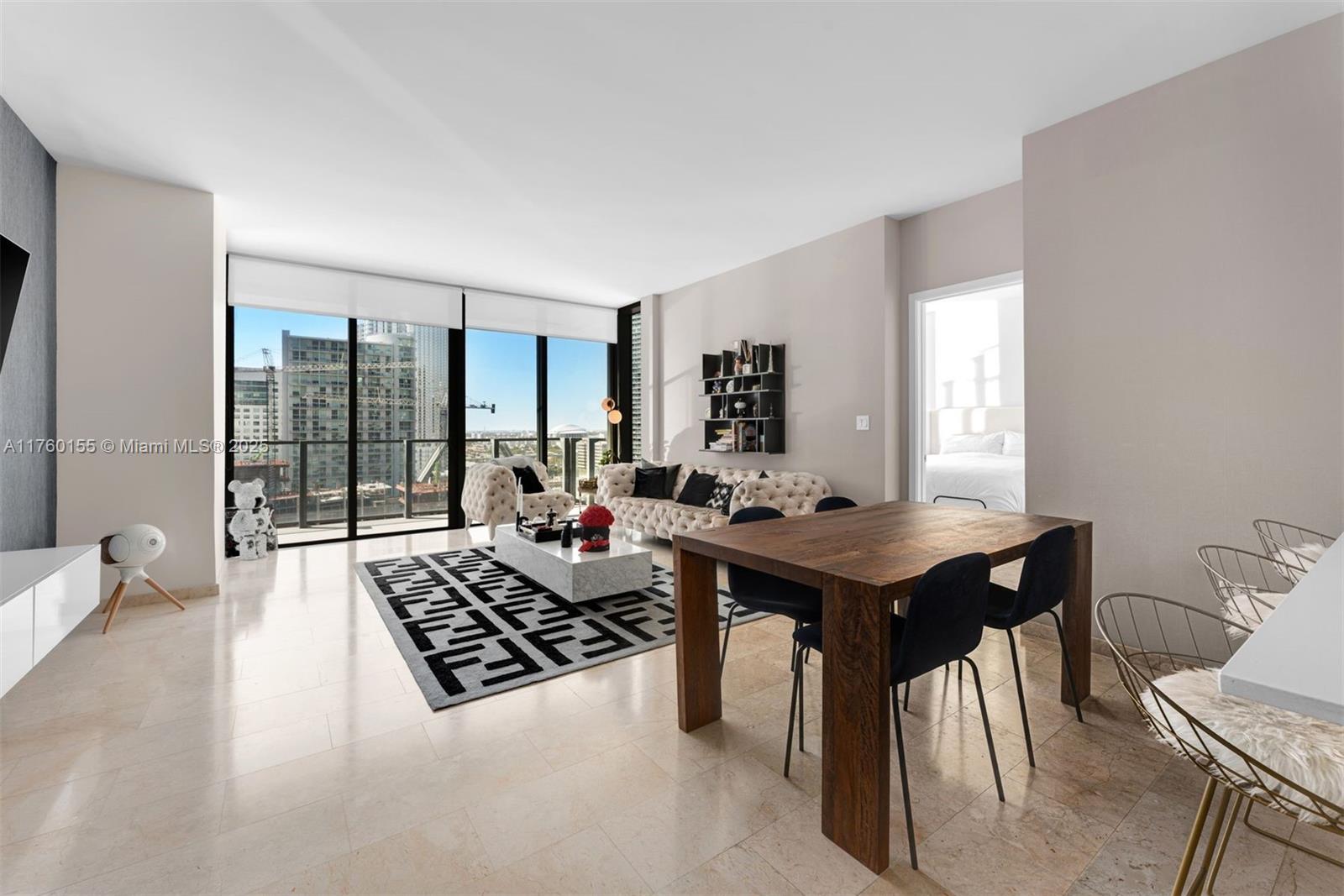 a living room with furniture rug and a large window