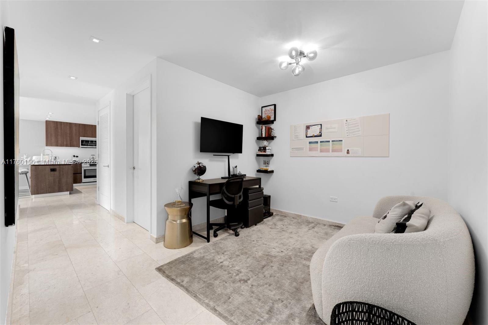 68 Southeast 6th Street, Unit 1404 Miami, FL 33131 - Photo 15 of 26 a living room with furniture and a flat screen tv