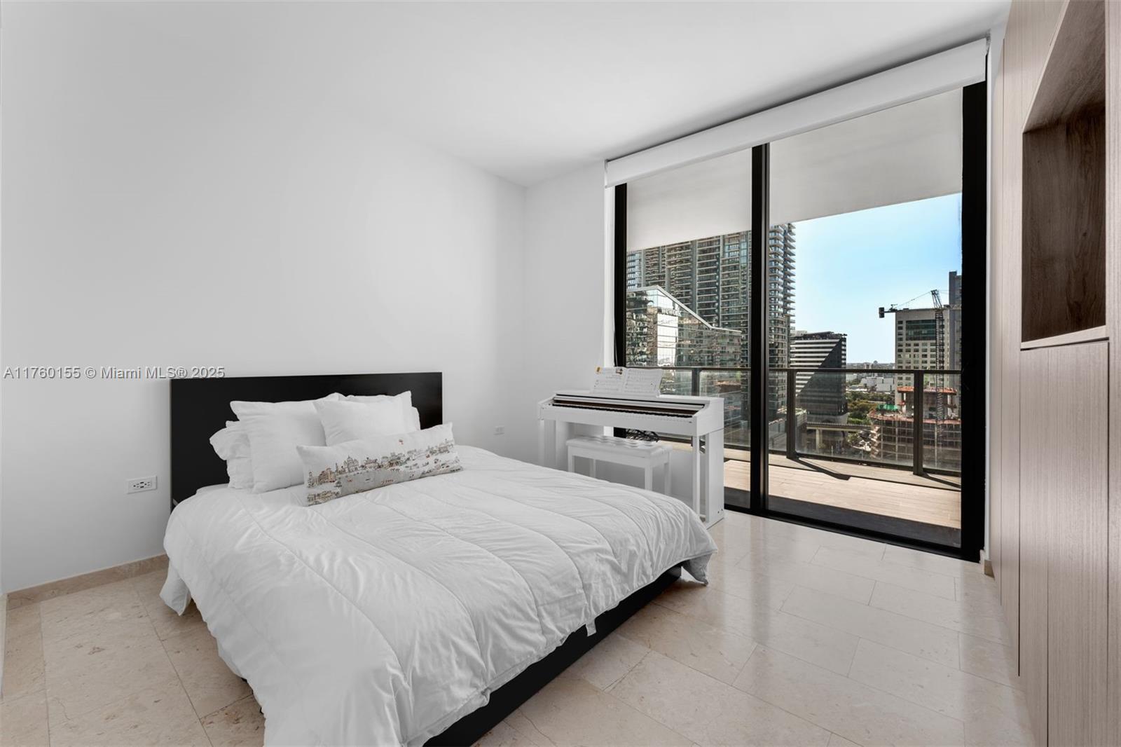 68 Southeast 6th Street, Unit 1404 Miami, FL 33131 - Photo 16 of 26 a bedroom with a large bed and a large window