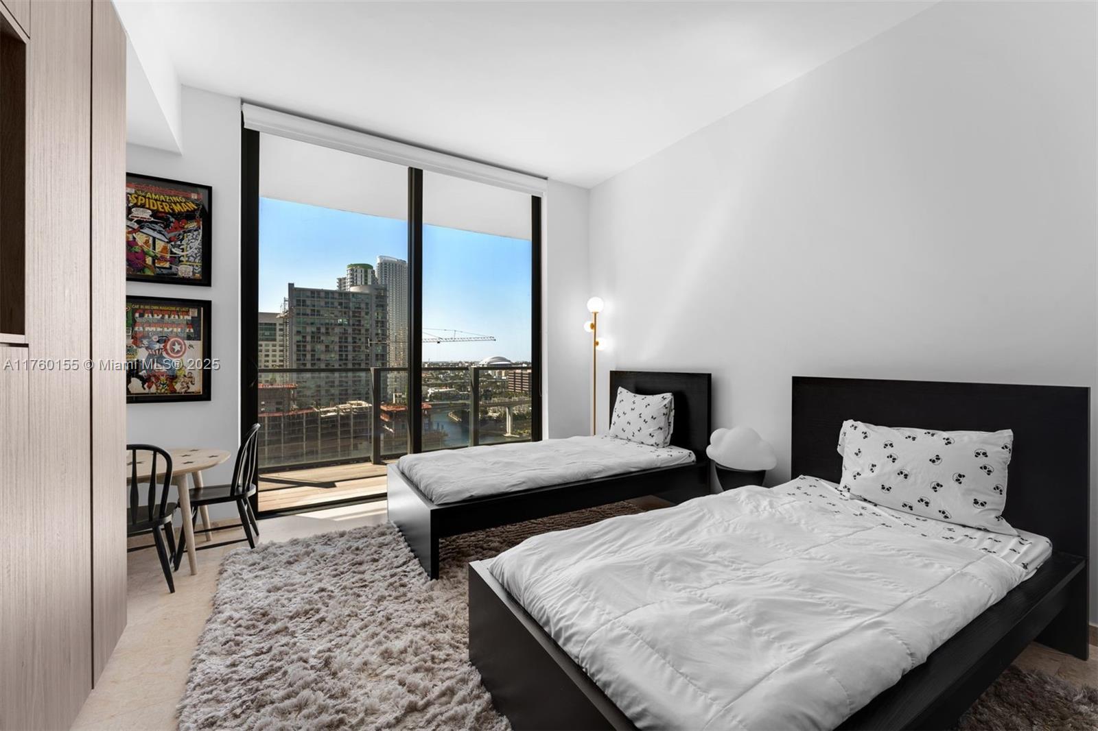 68 Southeast 6th Street, Unit 1404 Miami, FL 33131 - Photo 18 of 26 a bedroom with a large bed and a large window