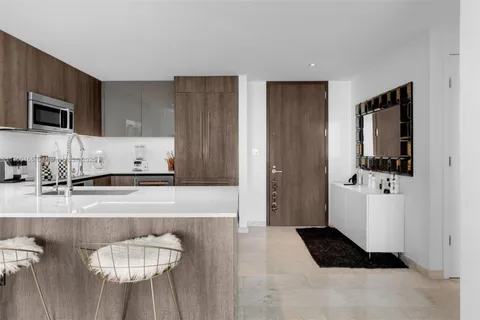 a kitchen with granite countertop cabinets and refrigerator