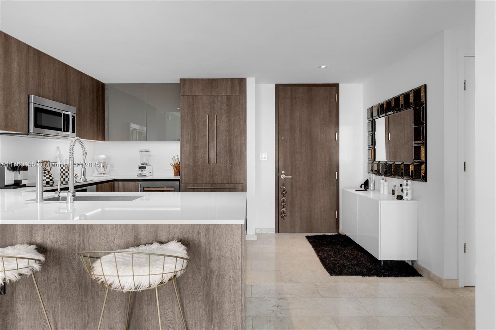 68 Southeast 6th Street, Unit 1404 Miami, FL 33131 - Photo 2 of 26 a kitchen with granite countertop cabinets and refrigerator