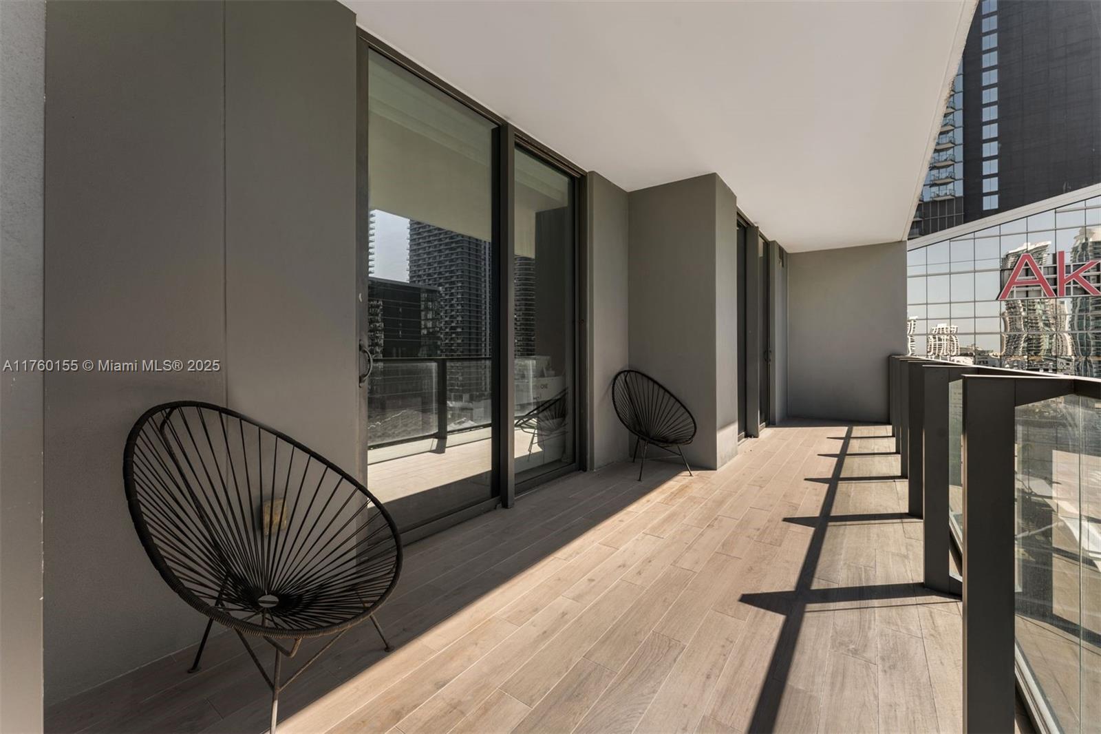 68 Southeast 6th Street, Unit 1404 Miami, FL 33131 - Photo 23 of 26 a bedroom with a bed and wooden floor