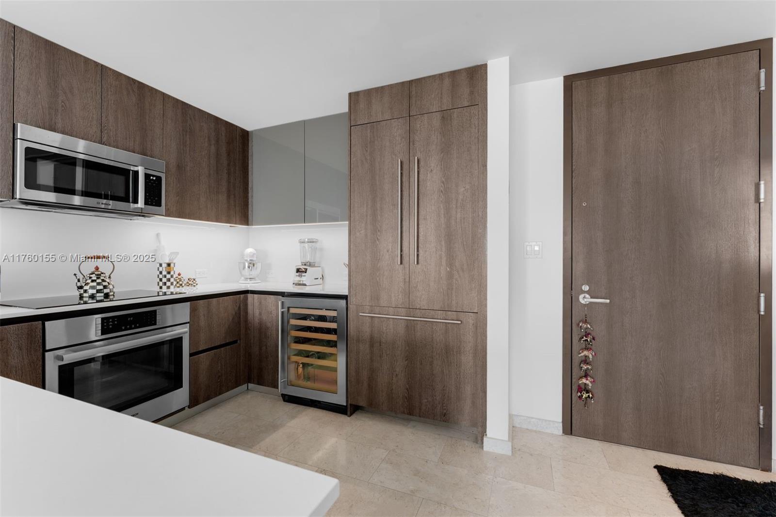 68 Southeast 6th Street, Unit 1404 Miami, FL 33131 - Photo 5 of 26 a kitchen with stainless steel appliances granite countertop a refrigerator and a stove top oven