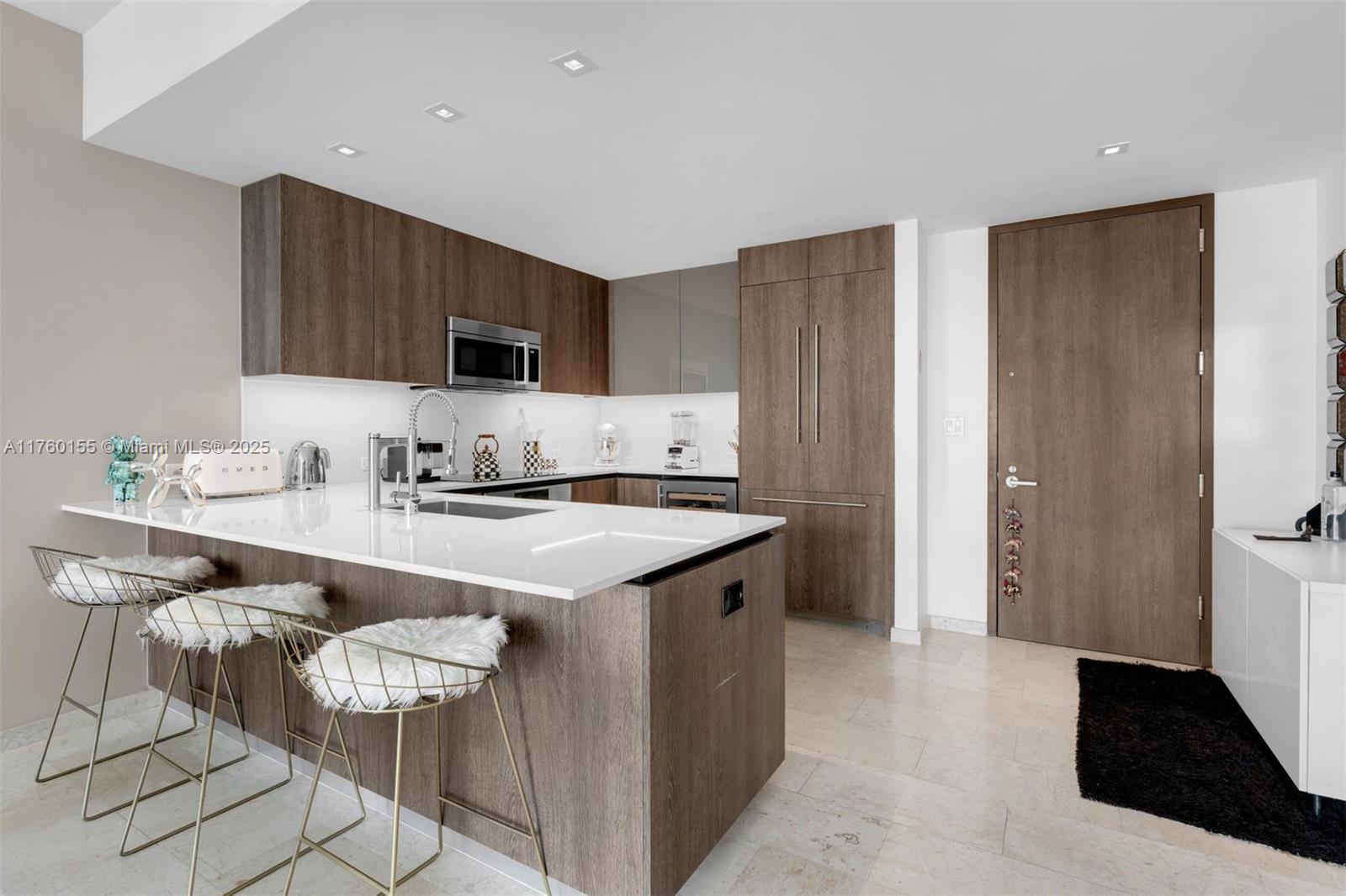 68 Southeast 6th Street, Unit 1404 Miami, FL 33131 - Photo 6 of 26 a kitchen with a sink a stove a refrigerator and cabinets