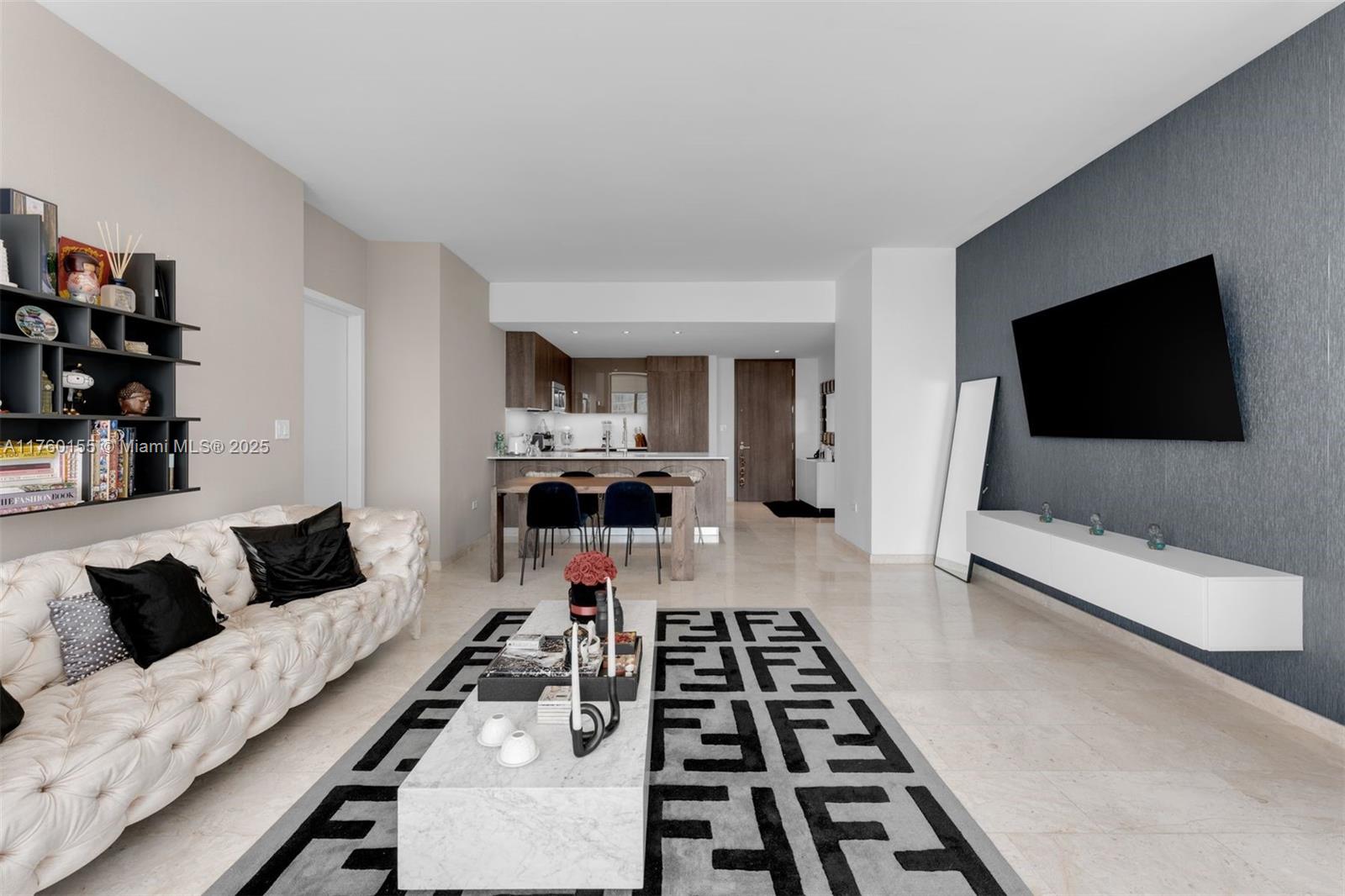 68 Southeast 6th Street, Unit 1404 Miami, FL 33131 - Photo 10 of 26 a living room with furniture and a flat screen tv