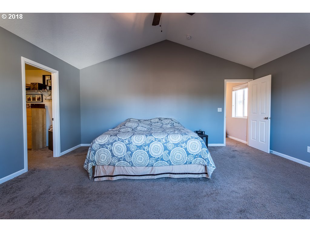 5047 Southwest 206th Place Beaverton, OR 97078 - Photo 12 of 28 a bedroom with a bed and a table