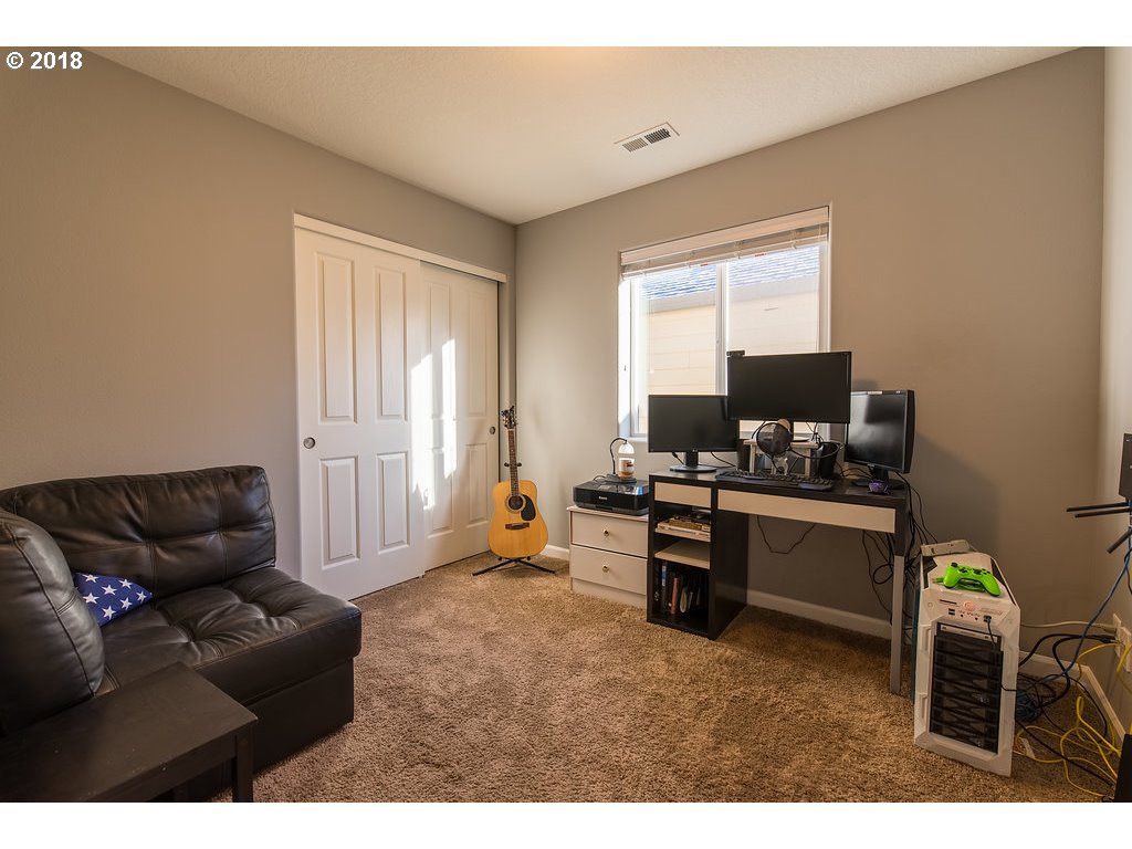 5047 Southwest 206th Place Beaverton, OR 97078 - Photo 16 of 28 a living room with furniture and a flat screen tv