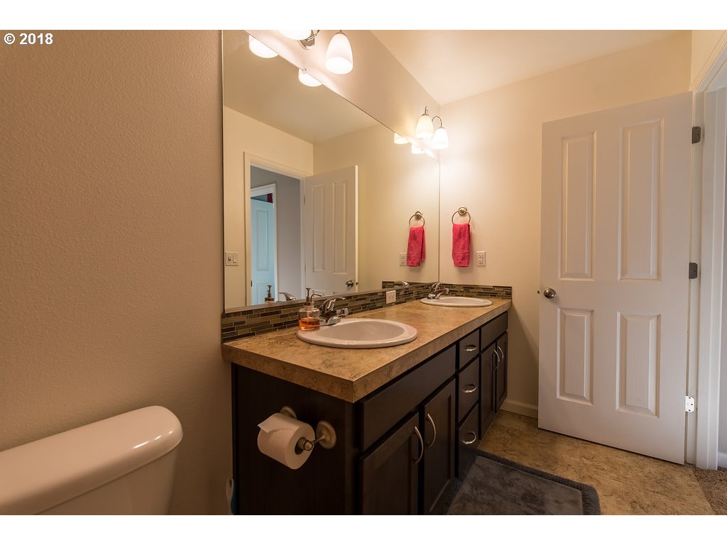 5047 Southwest 206th Place Beaverton, OR 97078 - Photo 18 of 28 a bathroom with a sink and a mirror