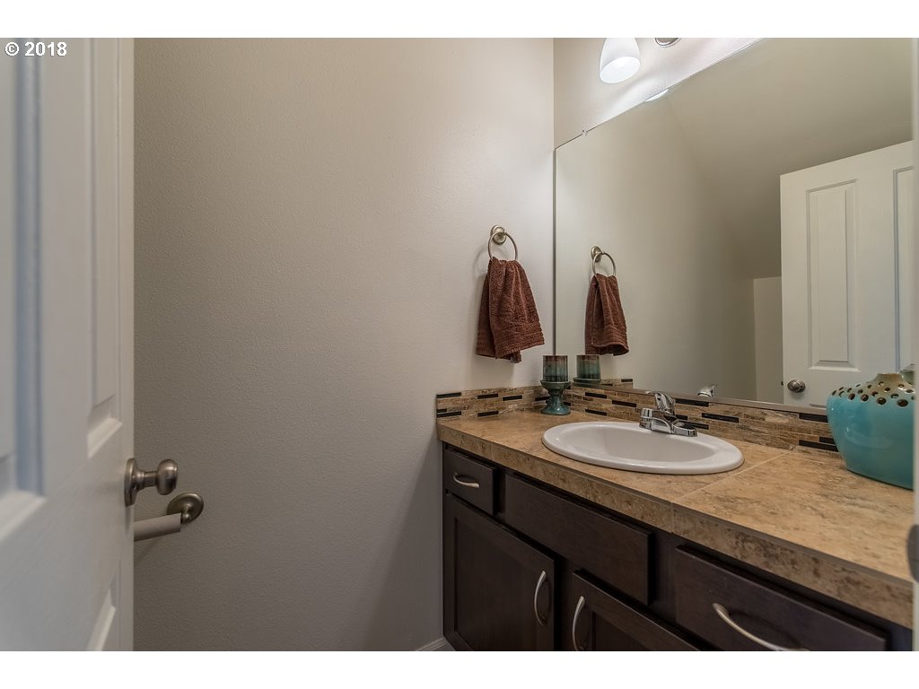 5047 Southwest 206th Place Beaverton, OR 97078 - Photo 20 of 28 a bathroom with a granite countertop sink and a mirror