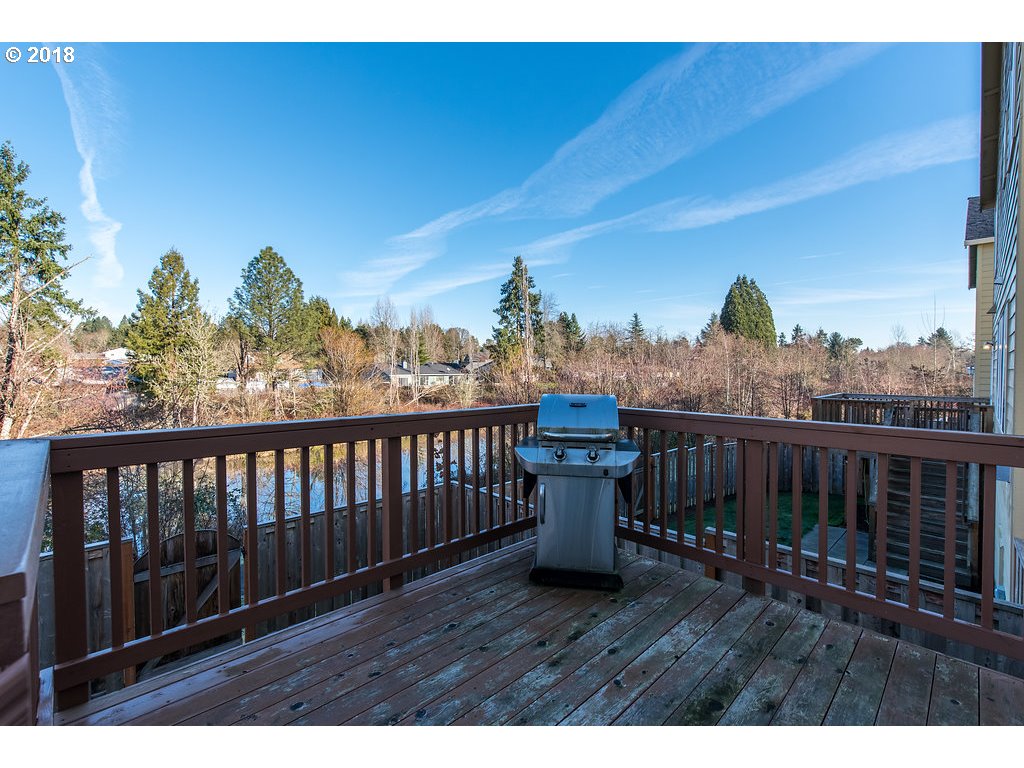 5047 Southwest 206th Place Beaverton, OR 97078 - Photo 28 of 28 a view of roof deck with wooden fence and trees