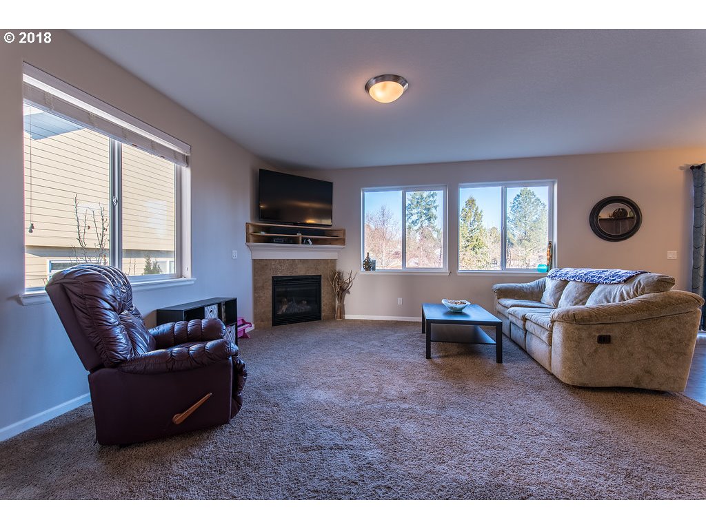 5047 Southwest 206th Place Beaverton, OR 97078 - Photo 3 of 28 a living room with furniture and a fireplace