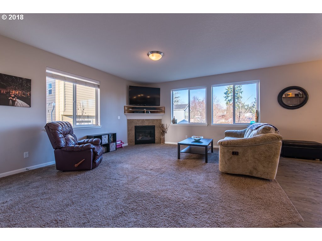 5047 Southwest 206th Place Beaverton, OR 97078 - Photo 4 of 28 a living room with furniture and a flat screen tv