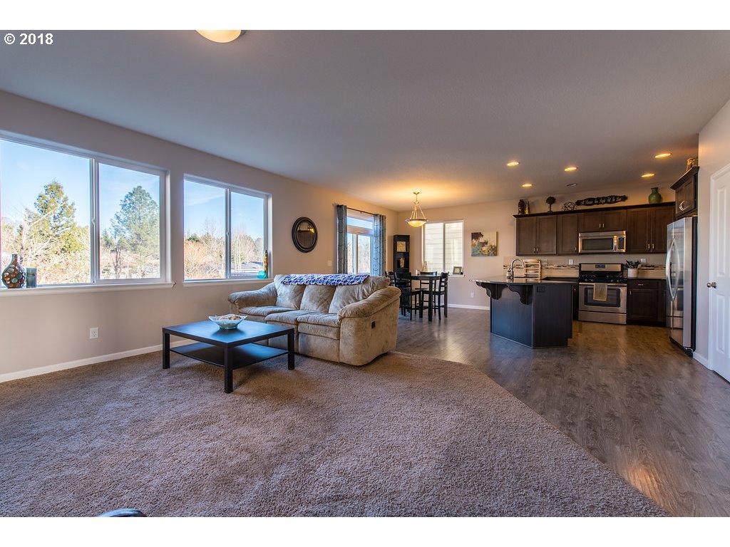 5047 Southwest 206th Place Beaverton, OR 97078 - Photo 5 of 28 a living room with furniture and a table