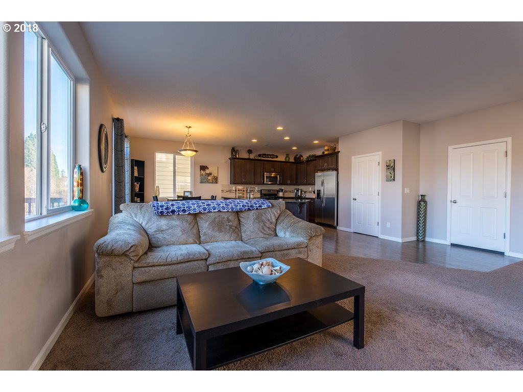 5047 Southwest 206th Place Beaverton, OR 97078 - Photo 6 of 28 a living room with furniture and a view of kitchen