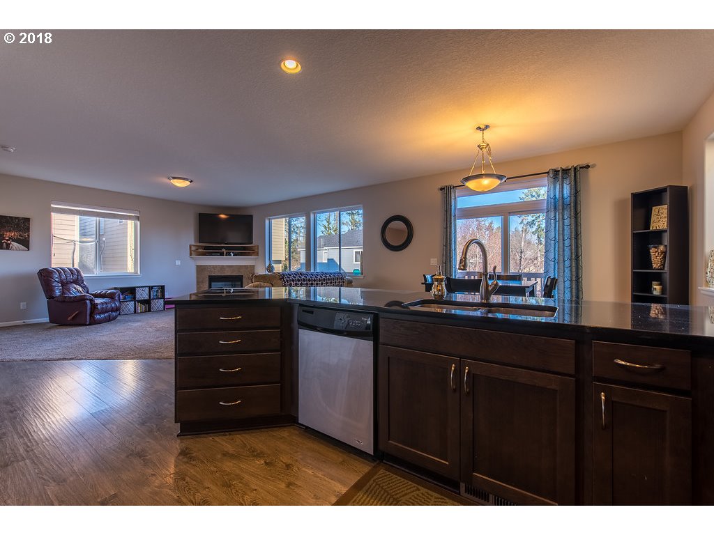 5047 Southwest 206th Place Beaverton, OR 97078 - Photo 7 of 28 a kitchen and a sink with cabinets