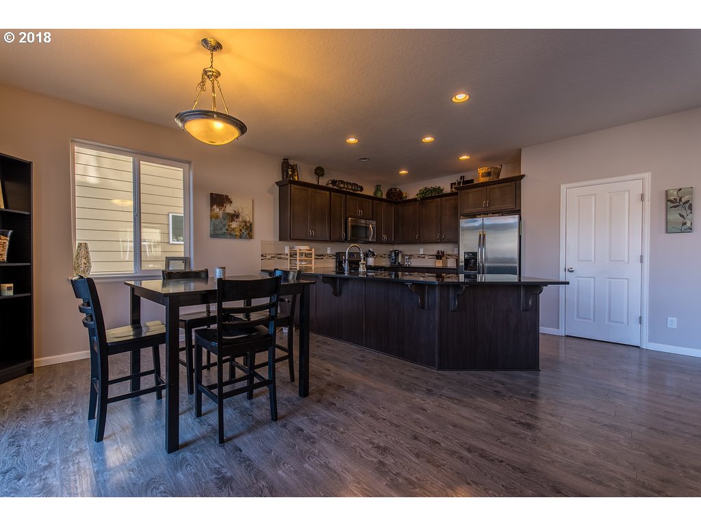 5047 Southwest 206th Place Beaverton, OR 97078 - Photo 10 of 28 a kitchen with a table and chairs in it