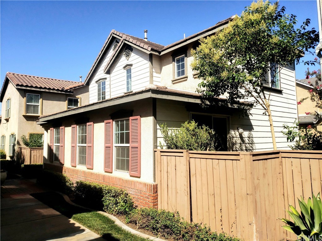 a view of a house with a window and wooden fence