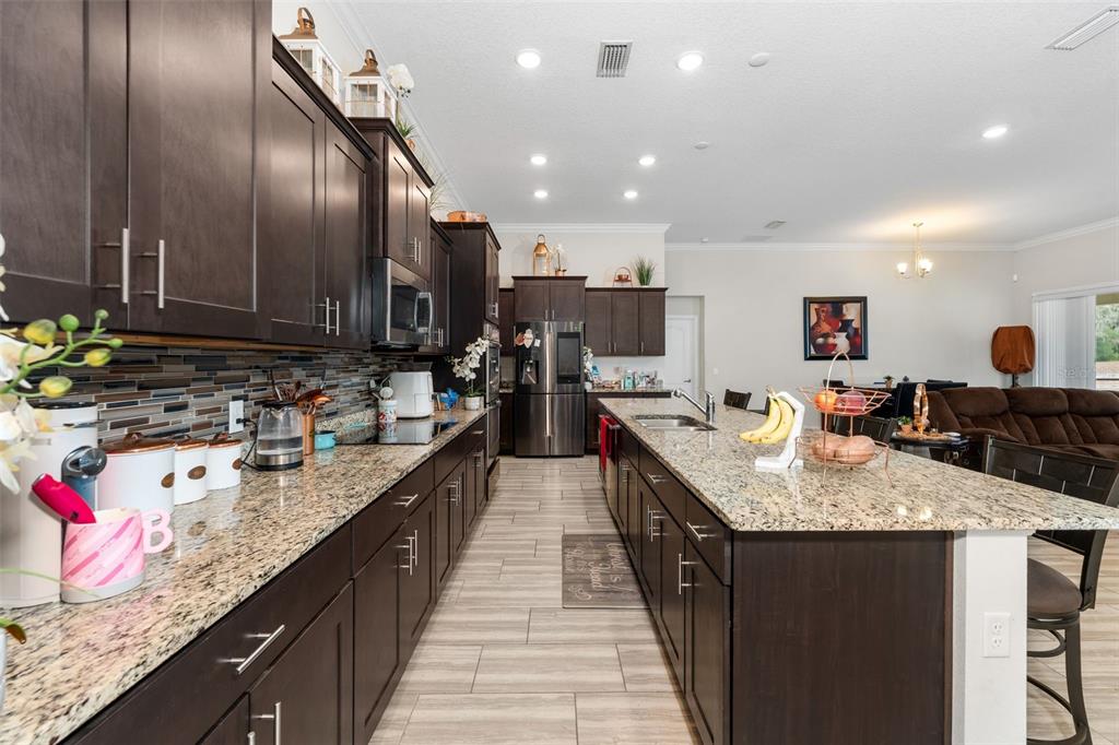 5615 Southwest 215th Terrace Newberry, FL 32669 - Photo 13 of 45 a kitchen with kitchen island granite countertop lots of counter top space