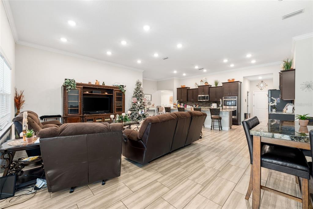 5615 Southwest 215th Terrace Newberry, FL 32669 - Photo 16 of 45 a living room with furniture and a flat screen tv