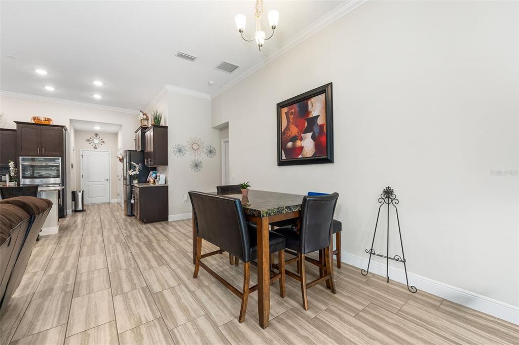 5615 Southwest 215th Terrace Newberry, FL 32669 - Photo 17 of 45 a view of a dining room with furniture and wooden floor