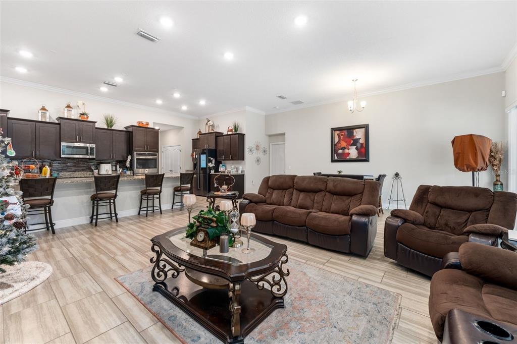 5615 Southwest 215th Terrace Newberry, FL 32669 - Photo 18 of 45 a living room with furniture kitchen view and a table
