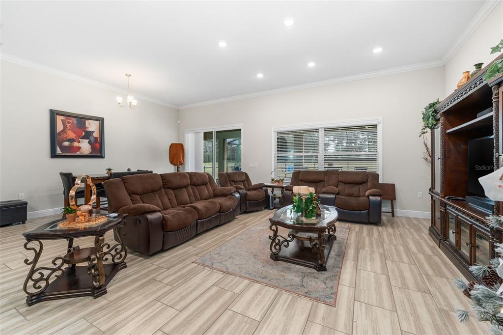 5615 Southwest 215th Terrace Newberry, FL 32669 - Photo 19 of 45 a living room with furniture a window and a flat screen tv