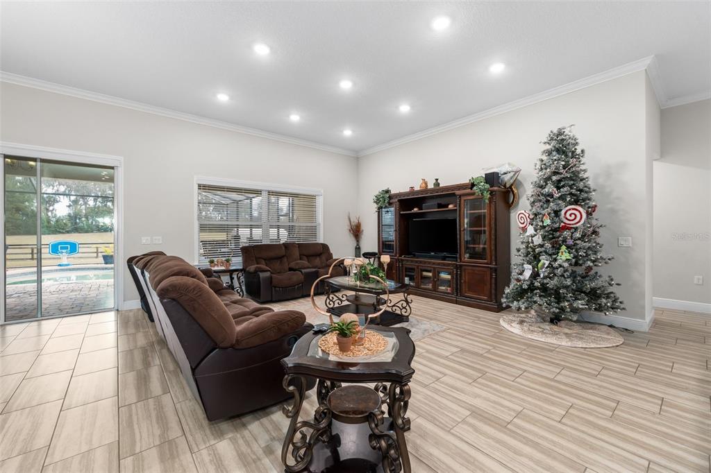 5615 Southwest 215th Terrace Newberry, FL 32669 - Photo 20 of 45 a living room with furniture a flat screen tv and a fireplace