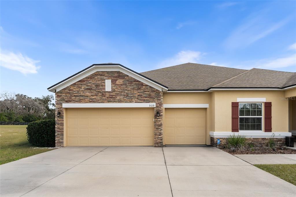 5615 Southwest 215th Terrace Newberry, FL 32669 - Photo 3 of 45 a front view of a house with a garden