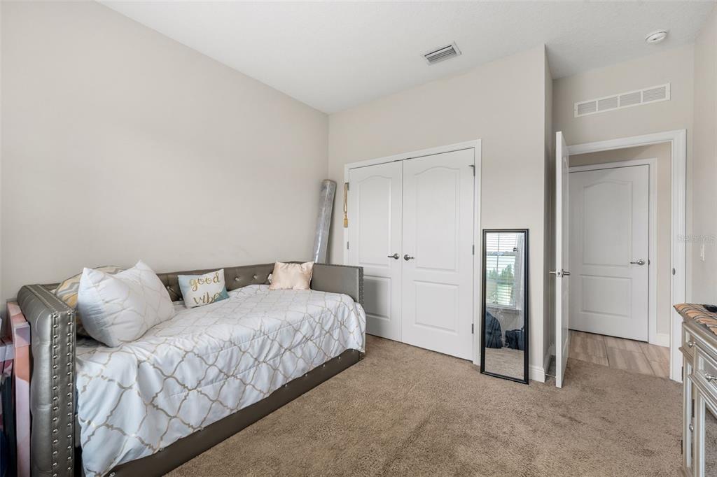 5615 Southwest 215th Terrace Newberry, FL 32669 - Photo 33 of 45 a bedroom with a bed and a refrigerator