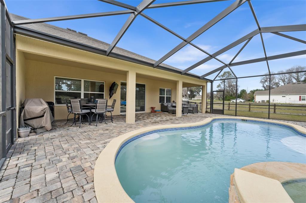 5615 Southwest 215th Terrace Newberry, FL 32669 - Photo 37 of 45 a view of a swimming pool with outdoor seating
