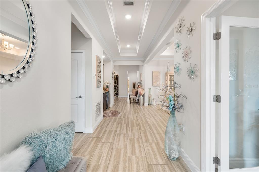 5615 Southwest 215th Terrace Newberry, FL 32669 - Photo 5 of 45 a view of a hallway to a livingroom with wooden floor and stairs