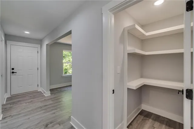a view of a hallway with wooden floor