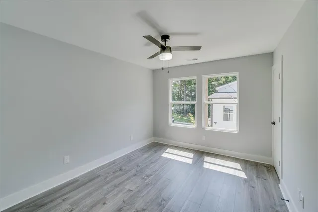 a bathroom with a granite countertop double vanity sink and a mirror