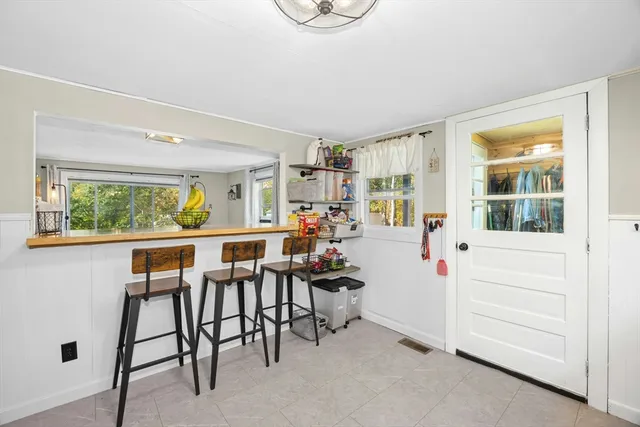 a dining room with furniture and a window