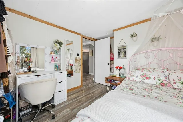 a bed room with a bed and a chair