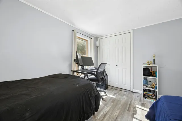 a bedroom with a bed and a chair