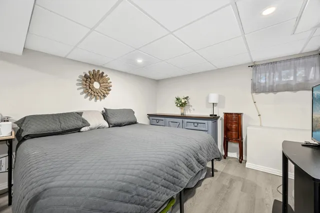 a bedroom with a bed and a painting on the wall