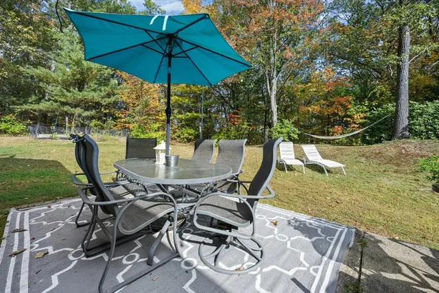 a view of an outdoor sitting area with furniture and backyard