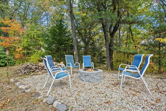 a chair and a table in a backyard of the house