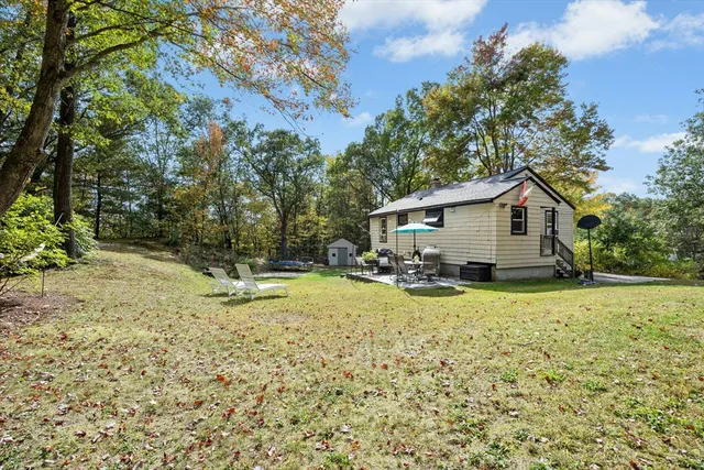 a view of backyard of house with green space