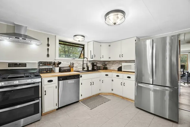 a kitchen with cabinets stainless steel appliances and a counter top space