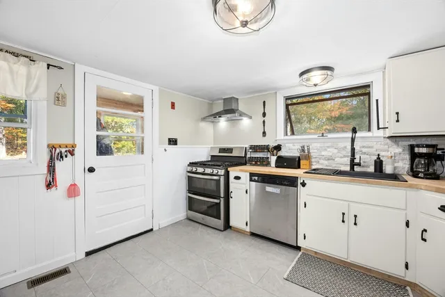 a kitchen with white cabinets and white appliances