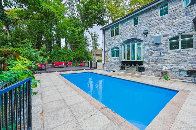 a swimming pool with outdoor seating and yard