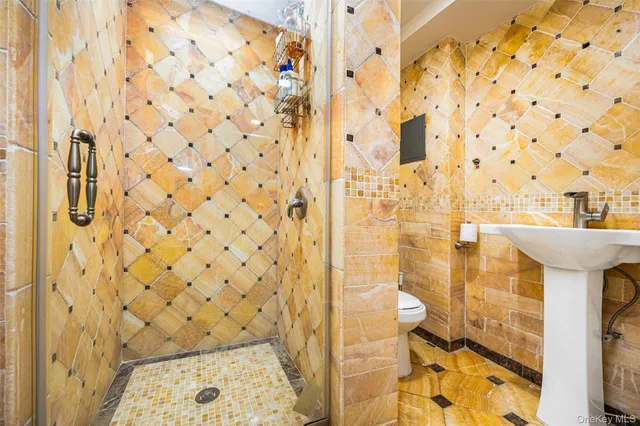 a bathroom with a sink a toilet and shower