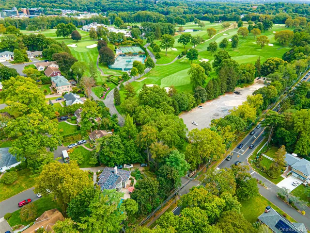 a view of a patio with a table and chairs under an umbrella