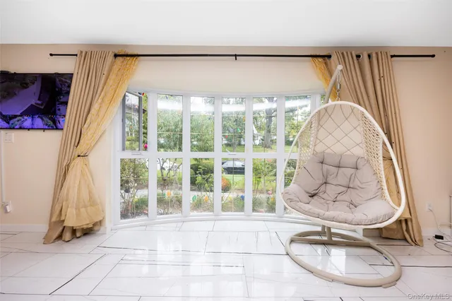 a large open kitchen with a large window and stainless steel appliances
