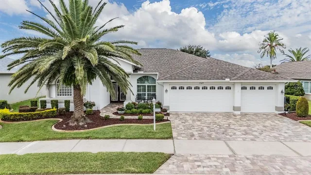 a front view of a house with a garden and patio