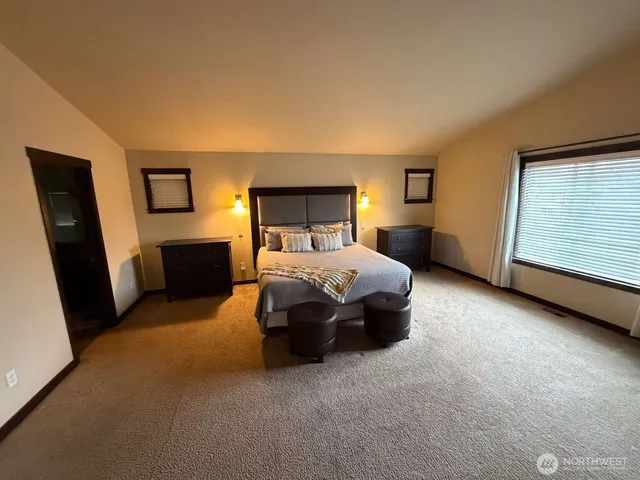 a bedroom with bed and window